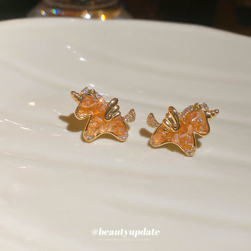 Styled view of orange bear stud earrings