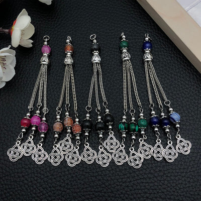 Black assorted shape charms arranged on a light background