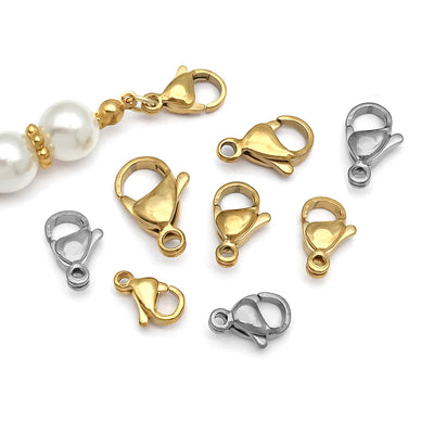 Gold-tone lobster clasp jewelry findings arranged on a light background