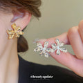 Sculpted Metal Flower Stud Earrings in Gold and Silver view 1