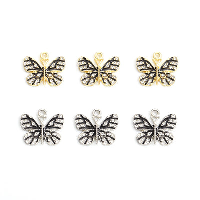 Black Enamel Butterfly Alloy Charm Pendants arranged on a white background