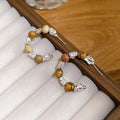 Brown And White Beaded Hoop Earrings In Two Patterns view 6