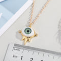 Gold Tone Green Eyeball Pendant Necklace with Spiked Lower Frame view 2