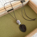 Black Cord Geometric Pendant Necklaces in Seven Designs view 9