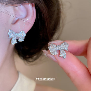 Crystal Bow Stud Earrings in Silver and Gold with Polished Metal Details