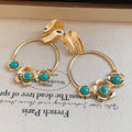 Turquoise Bead Floral Hoop Drop Earrings with Polished Metal Tone Details view 6