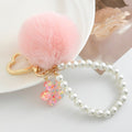 Pink Faux Fur Pom Keychain with Pearl Strand and Glitter Flower Charm view 3
