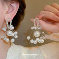 Gold Tone Bow Earrings With White Pearl And Crystal Clusters view 1