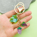 Strawberry, Cherry and Lemon Charm Keychains Featuring Purple Grape Across 43 Variations view 1