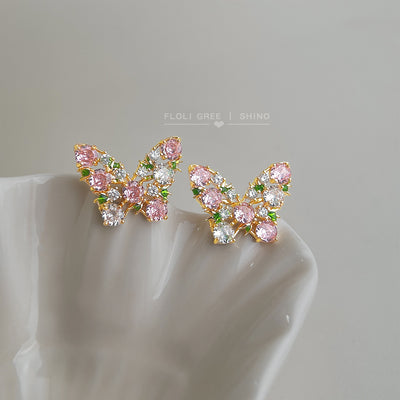 Gold-tone pink-green-clear-stone butterfly studs in the first product display.