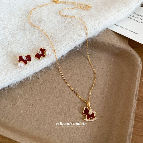 Horse necklace and studs displayed on felt tray
