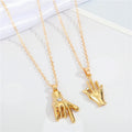 Gold Tone Hand Gesture Pendant Necklaces in Two Distinct Designs view 1