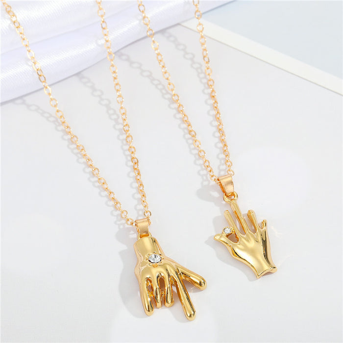 Gold Tone Hand Gesture Pendant Necklaces in Two Distinct Designs