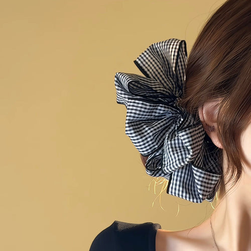 Black white gingham oversized bow scrunchie worn at nape of hair