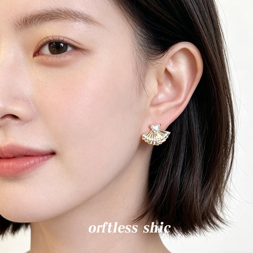 Gold fan triangle CZ stud earring worn on ear front view