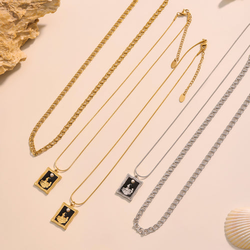 Flat lay gold and steel double layer necklaces with square enamel pendants