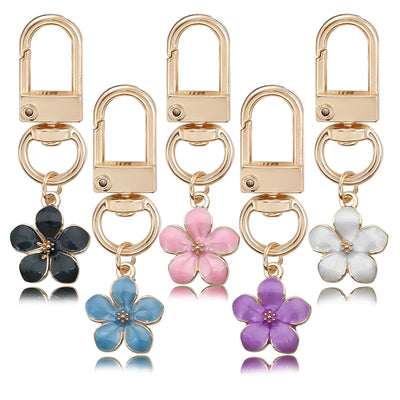 Image 1 showing flower shaped metal key chain.