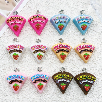 Multicolor strawberry and cake charms arranged on a light background