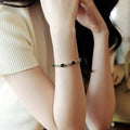 Gold Tone Bracelet With Green Oval Stones And Crystal Flowers view 4
