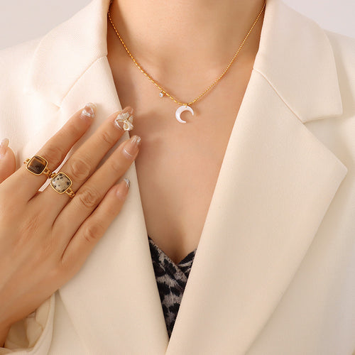 Model wearing gold-tone white shell crescent moon pendant necklace