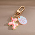 Gold Tone Balloon Dog Clip Keychains with Pearl Collars and English Tags view 3