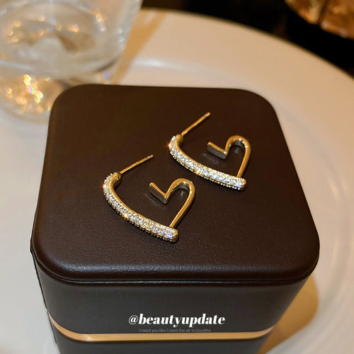 Gold Tone Crystal Open Heart Statement Hoop Stud Earrings shown in ear-worn front view