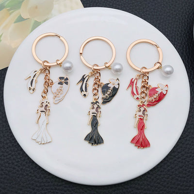 Overview showing the available color and design variations of the white black and red dress mannequin metal keychain