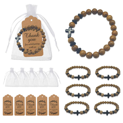 A wood bead cross bracelet is displayed with white organza bags, brown thank-you tags, and multiple bracelet units.