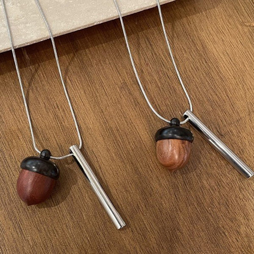 A long silver-tone chain with a brown wood-look acorn and slim bar drops, display view