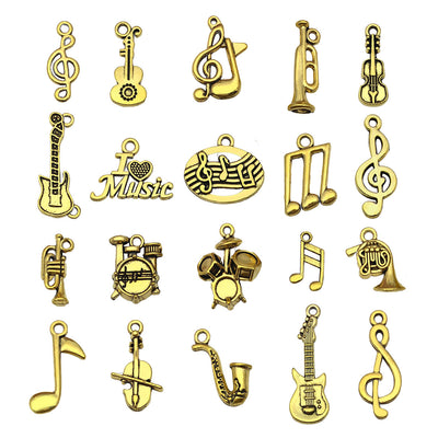 Matte gold-tone guitar and musical instrument charms arranged on a light background