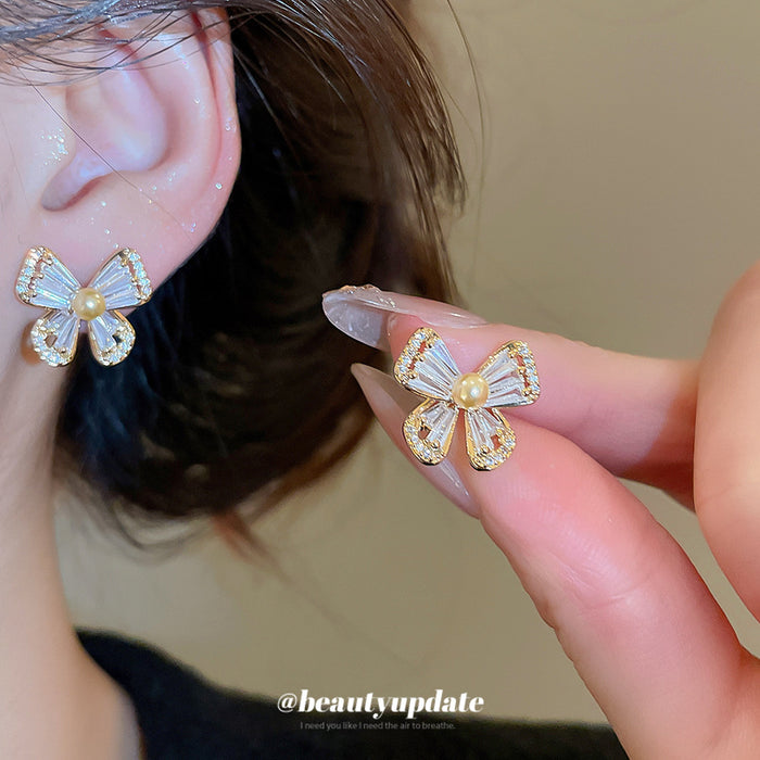Gold Tone Bow Stud Earrings with Clear Stones and Pearl Centers