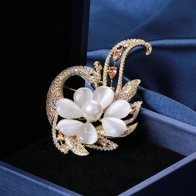 Champagne cats eye flower phoenix brooch on blue velvet