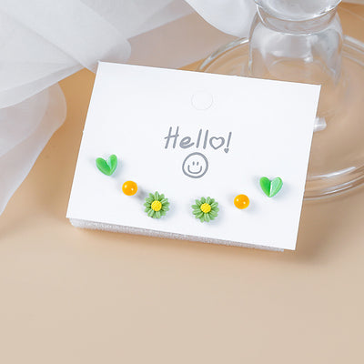 Three-pair studs on Hello card with glass and fabric
