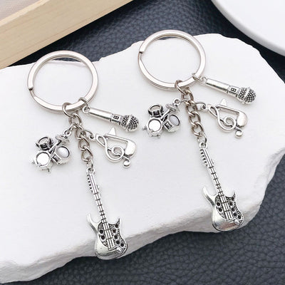Main display of silver tone guitar drum and saxophone music keychains