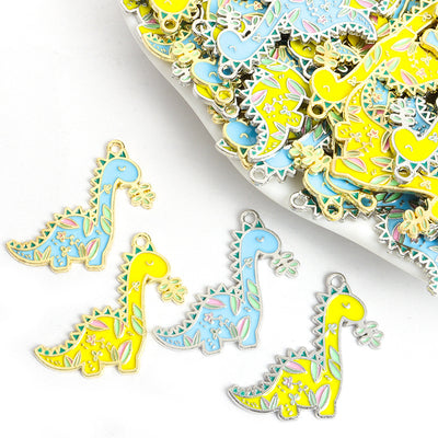 Assorted dinosaur charms arranged on a white surface