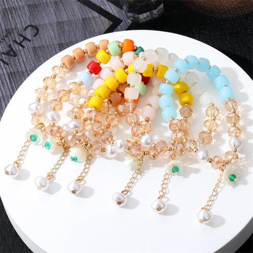 Stack of six beaded stretch bracelets multicolor white blue yellow pink orange