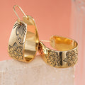 Gold Tone Wide Hoop Earrings With Black Floral Line Art view 2