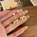 Gold and Silver Rocking Horse Pearl Look Dangle Earrings view 3
