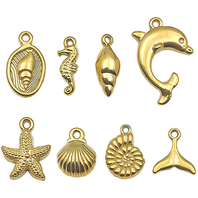 Gold-tone starfish and seahorse charms arranged on a light background