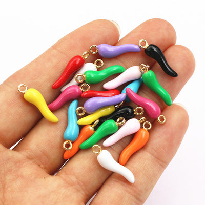Front overview of colorful enamel chili pepper charms with gold tone loops arranged on a light background