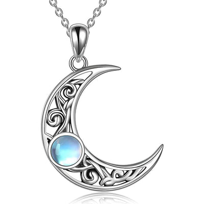 Close-up silver filigree crescent moon pendant showing cabochon glow