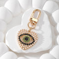 Gold Tone Rhinestone and Faux Pearl Heart Evil Eye Clip Keychains view 6