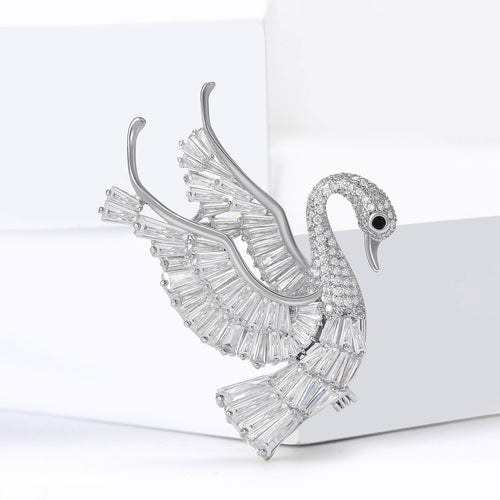 Angled display of swan with raised layered wings and clear stone accents