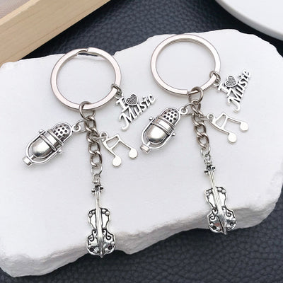Main display of silver tone violin microphone and music note keychain