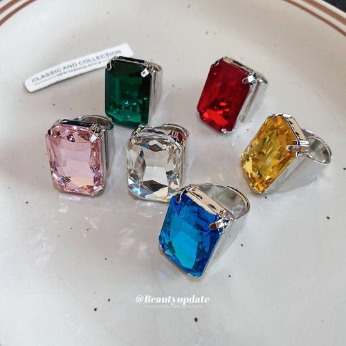 Six rectangular CZ silver open rings multicolor on white plate