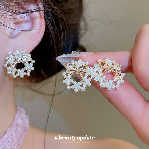 styled close view of pearl-look bow stud earrings