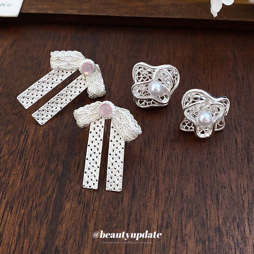 Crystal Bow and Filigree Flower Stud Earring Collection shown in a display view