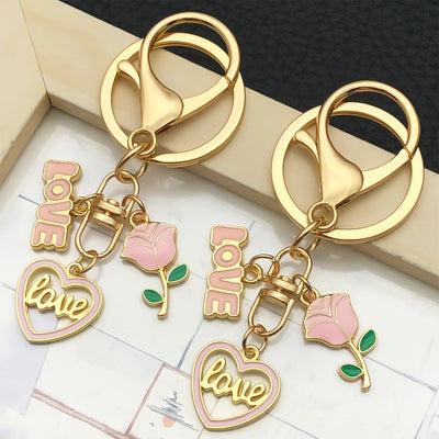 Overview showing the available color and design variations of the pink love rose and heart metal keychain