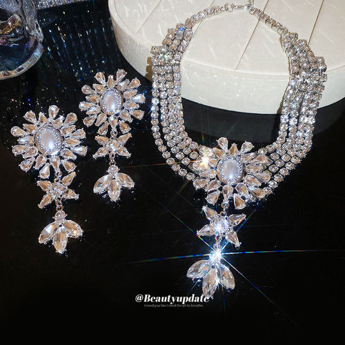 Silver multi strand crystal flower necklace and earrings on black