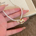 White Pearl Look Necklace with Gold Tone Horse Pendant view 2